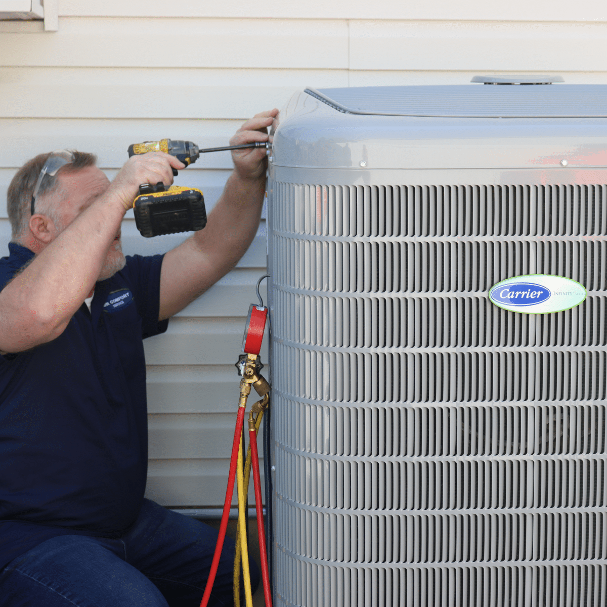 technician servicing AC unit