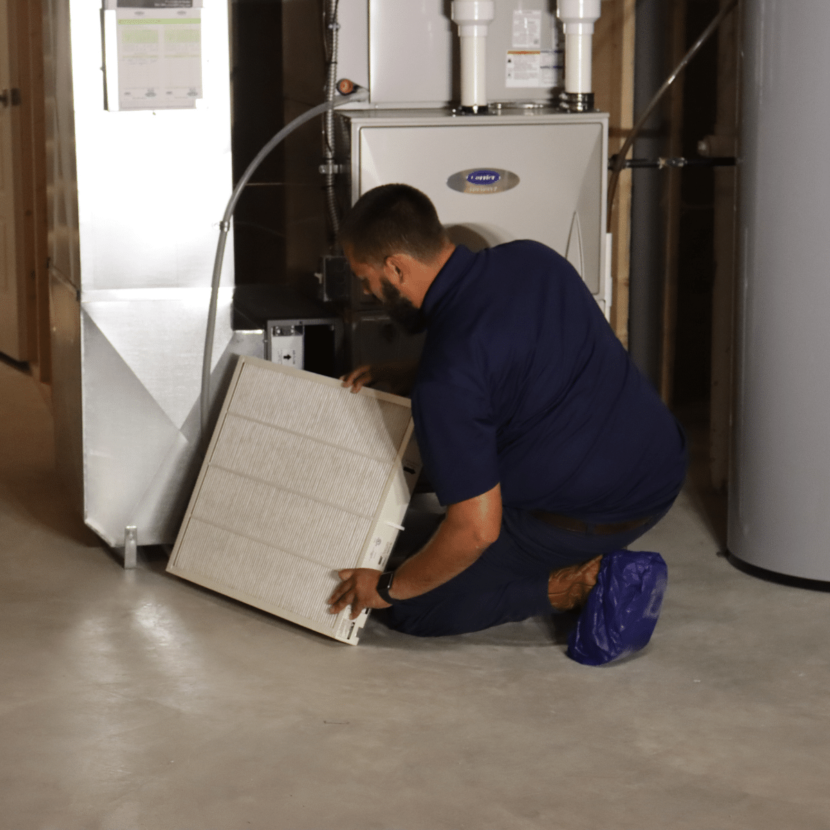 heating services hazelwood mo technician servicing furnace filter