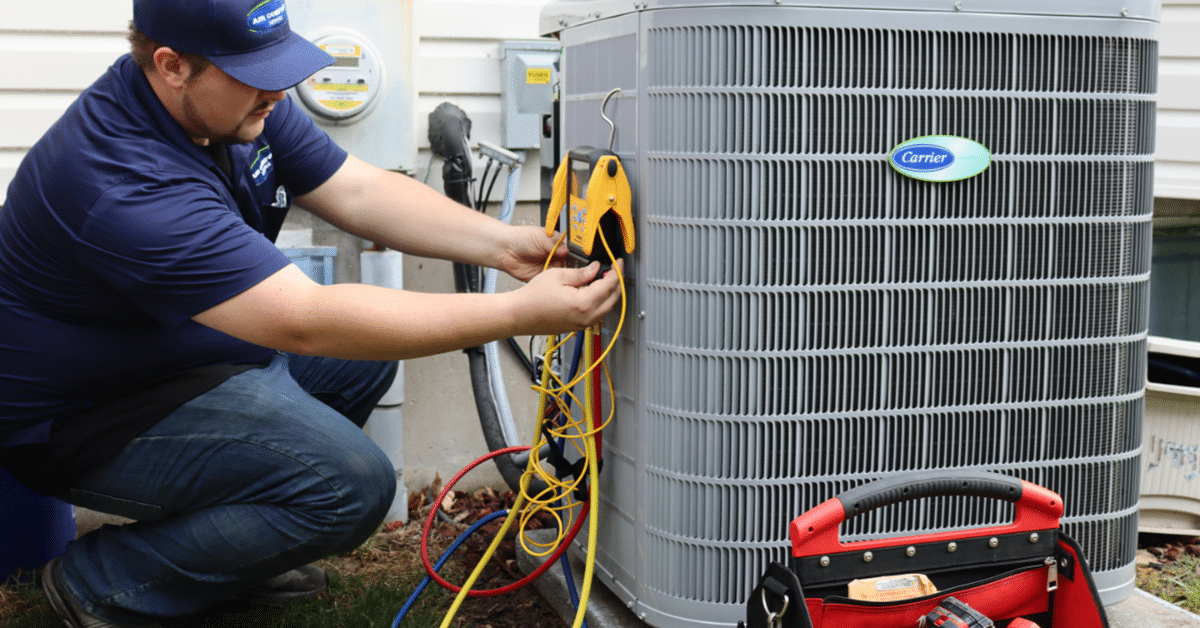 technician servicing ac unit