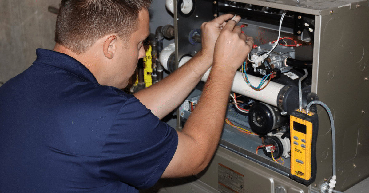 technician servicing furnace