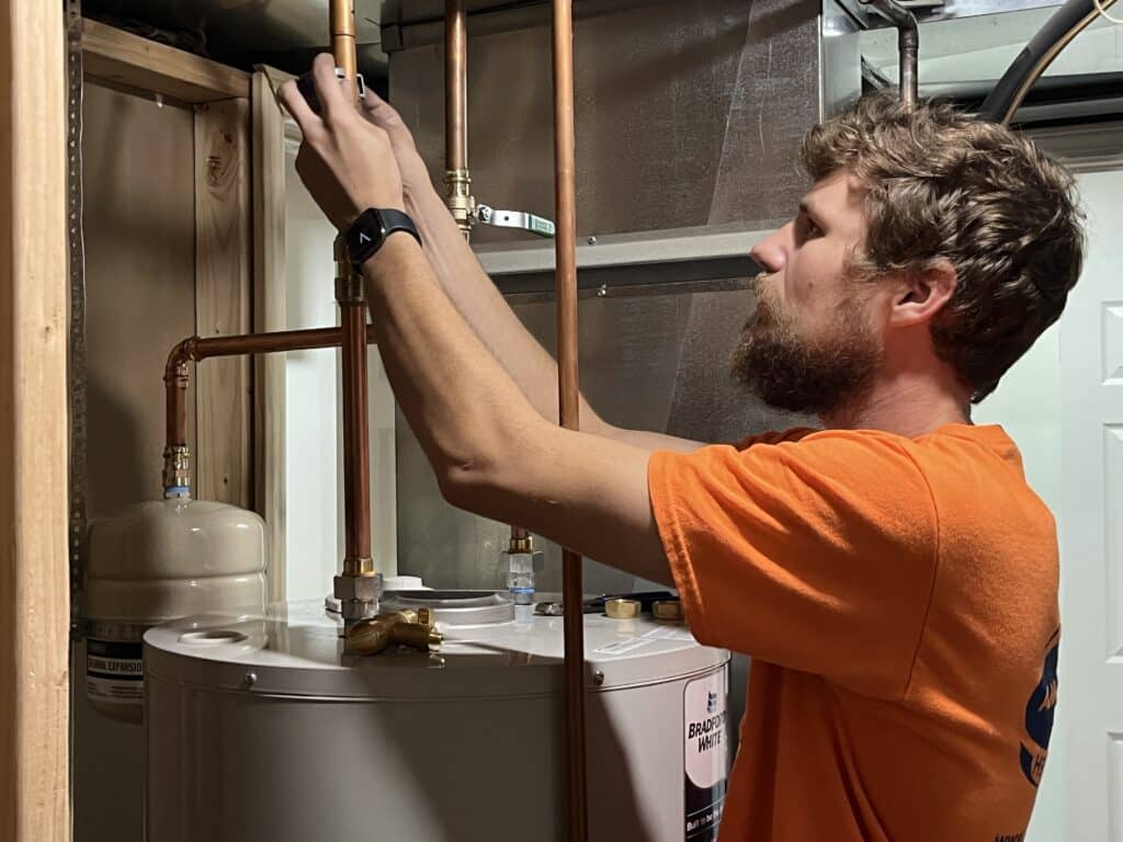 technician servicing water heater