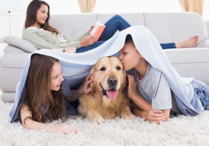 kids with dog mom reading shutterstock_256175107